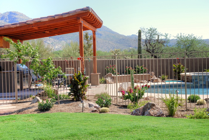 Mediterranean-style landscape design with layered plantings and warm hardscape