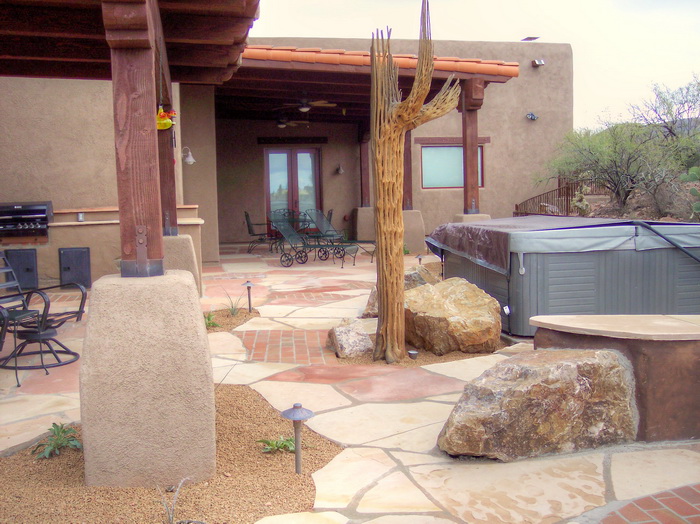Old World-themed backyard landscape design with stone details